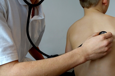 doctor checking child's lungs